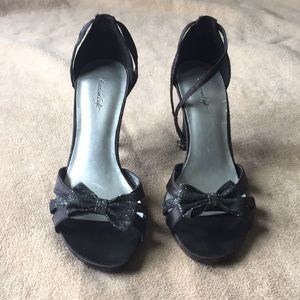 Black strappy sandals with silvery bow detail